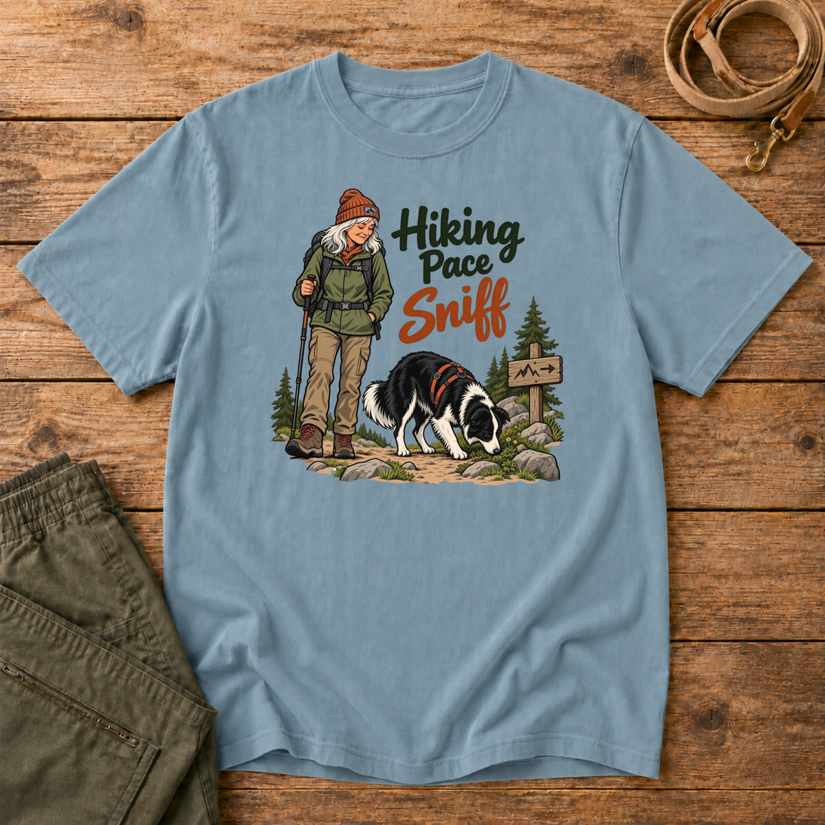 Adventure Dogs Life T-shirt in ice blue, a light blue, featuring a hiker and border collie on a mountain trail with "Hiking Pace Sniff" lettering.